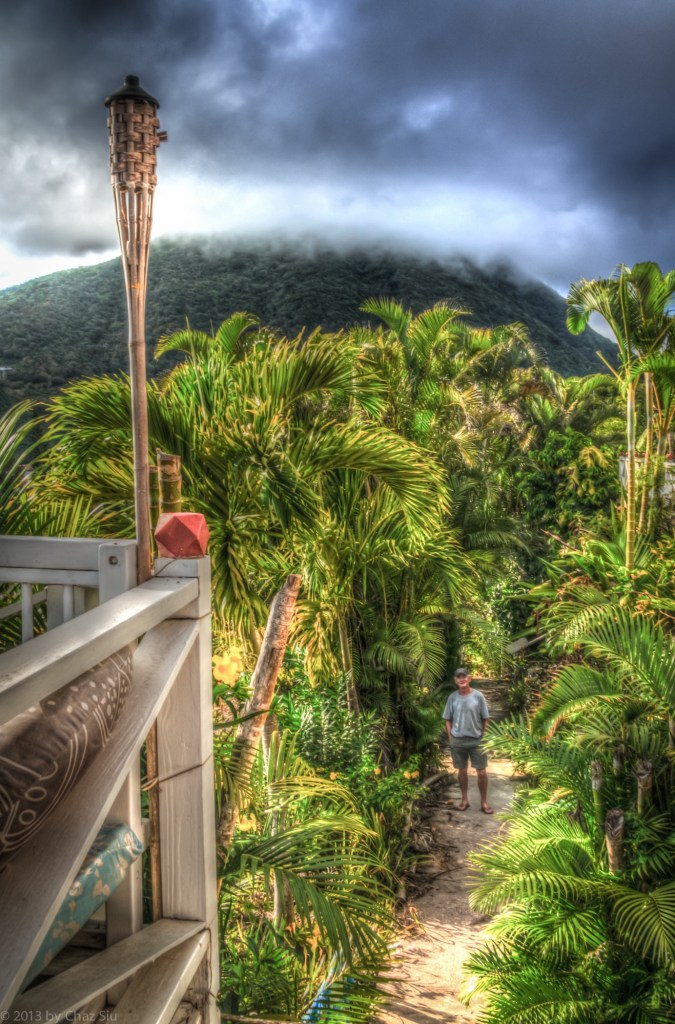 Irish Michael McAuliffe At The Entryway For El Momo Cottages As Mt Scenery Looms Above