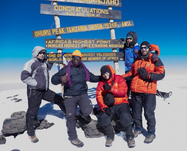 Uhuru Peak Summit - The Roof Of Africa. L to R, Alex, JT, me, Caryl, Paul. Rhys, Cort, and Kitt had summited an hour a head of us. 